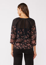 [Color: Black/Dusty Rose] A back facing image of a brunette model wearing a sheer chiffon black blouse with a pink floral print. A lightweight top featuring a button front, split v neckline, and 3/4 length sleeves. Ideal for special occasions and holiday events. 