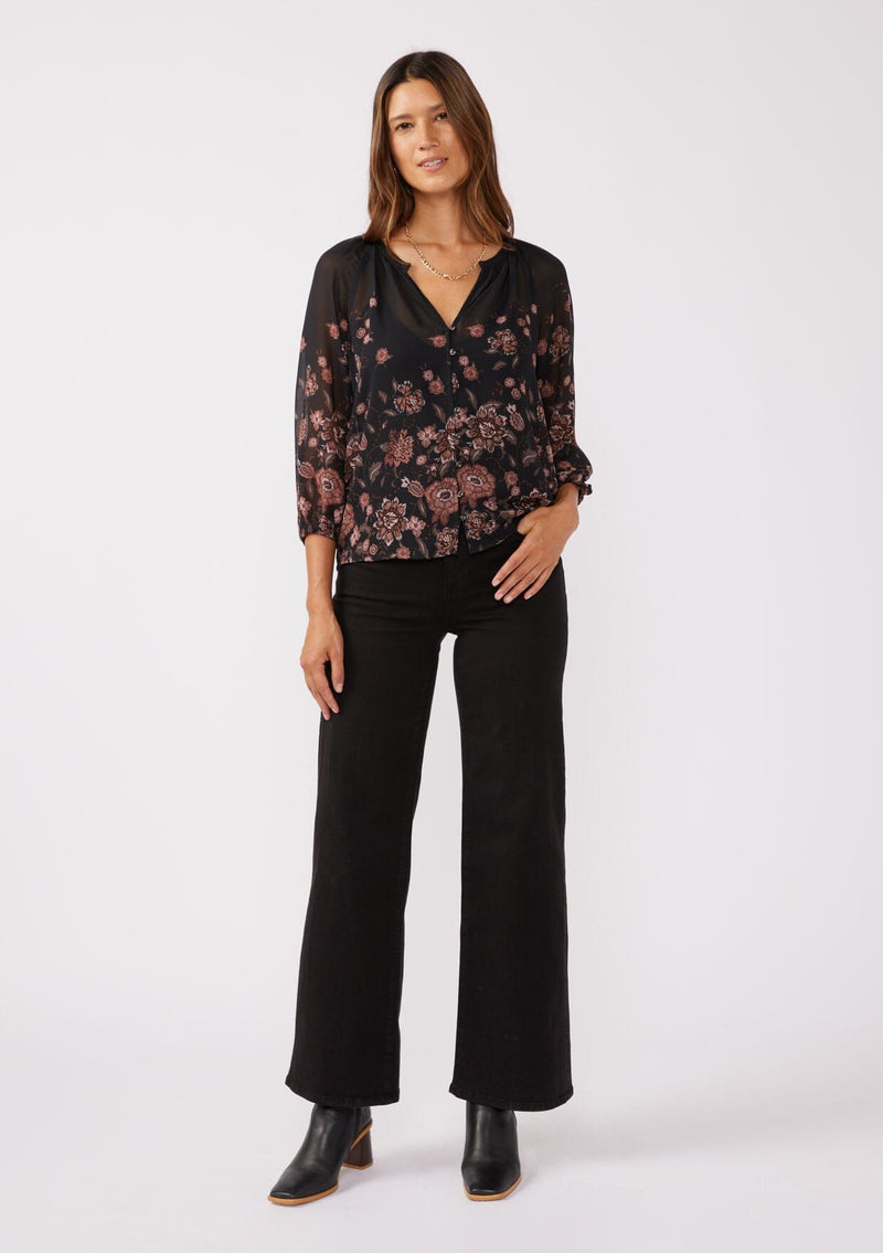 [Color: Black/Dusty Rose] A full body front facing image of a brunette model wearing a sheer chiffon black blouse with a pink floral print. A lightweight top featuring a button front, split v neckline, and 3/4 length sleeves. Ideal for special occasions and holiday events. 