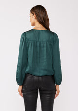 [Color: Teal] A back facing image of a brunette model wearing a holiday green silky polyester satin top. This special occasion top features a surplice v neckline, front hook and eye closure, elastic hemline, and long sleeves. Perfect for Christmas and holiday parties. 