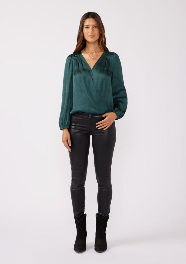 [Color: Teal] A full body front facing image of a brunette model wearing a holiday green silky polyester satin top. This special occasion top features a surplice v neckline, front hook and eye closure, elastic hemline, and long sleeves. Perfect for Christmas and holiday parties. 