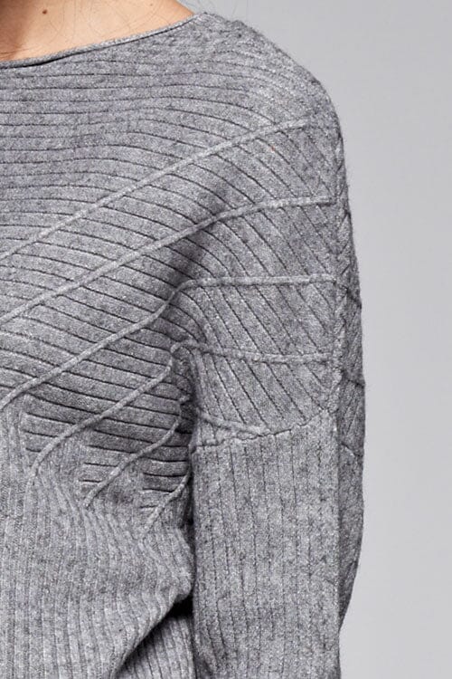 [Color: Heather Grey] A detail image of a brunette model wearing a grey ribbed sweater with cozy long dolman sleeves. 