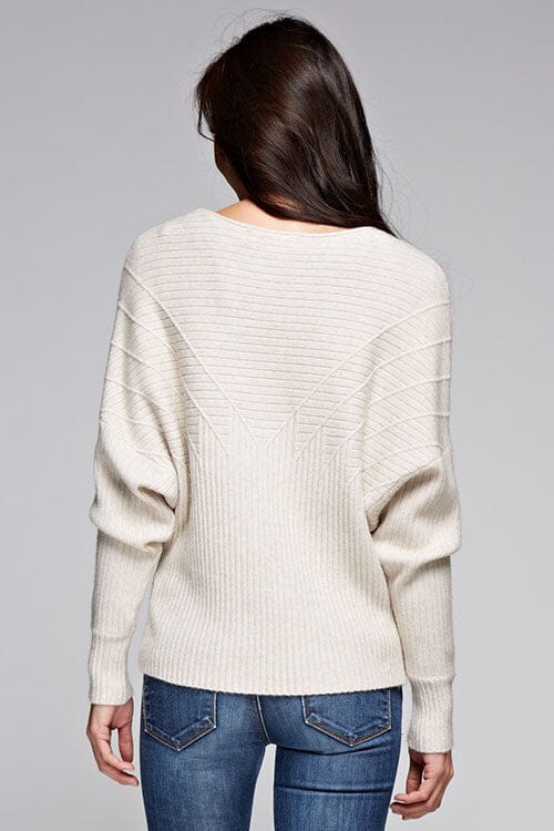 [Color: Oatmeal] A back facing image of a brunette model wearing an off white ribbed sweater with cozy long dolman sleeves. 