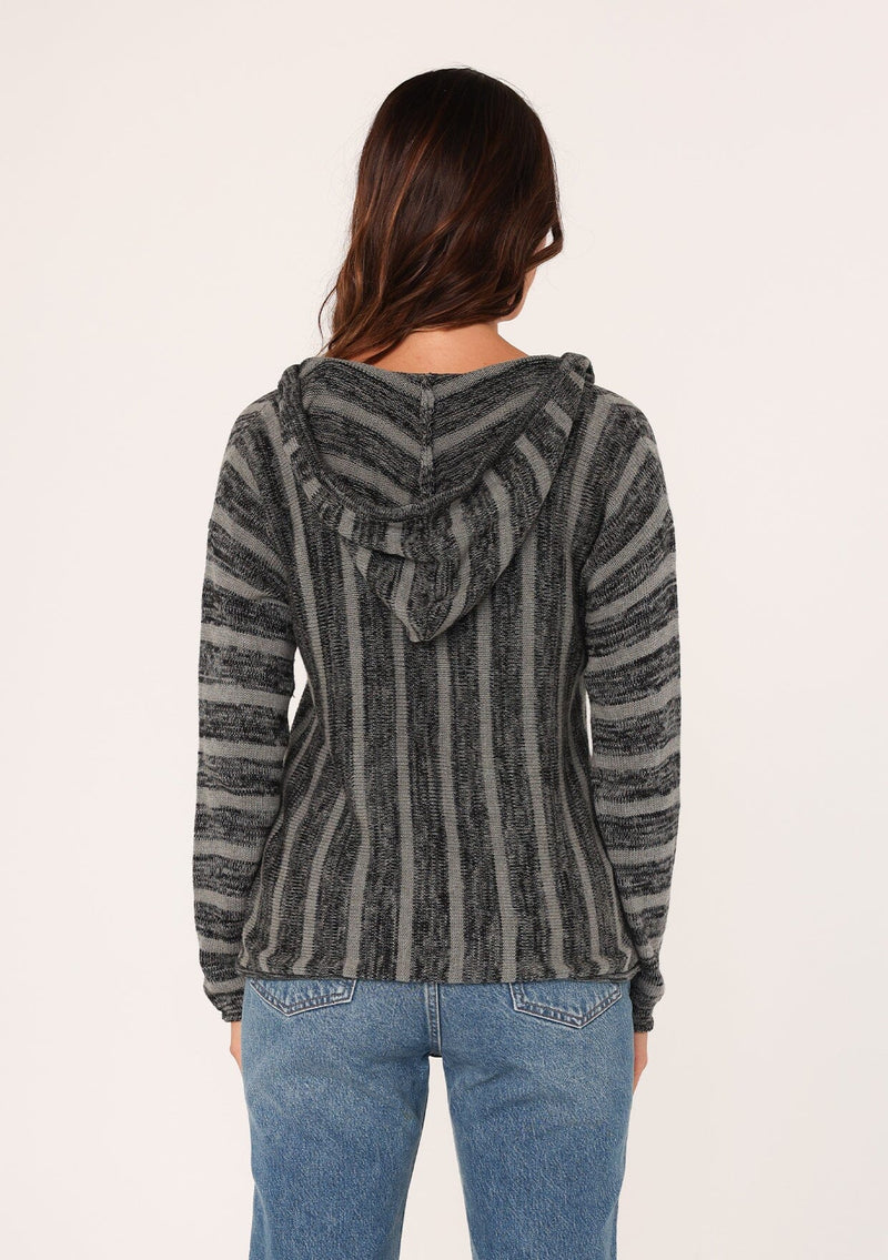 [Color: Black/Grey] A back facing image of a brunette model wearing a striped pullover hoodie with a drawstring and front kangaroo pocket. A versatile sweater, perfect for casual outings or beach styling. 