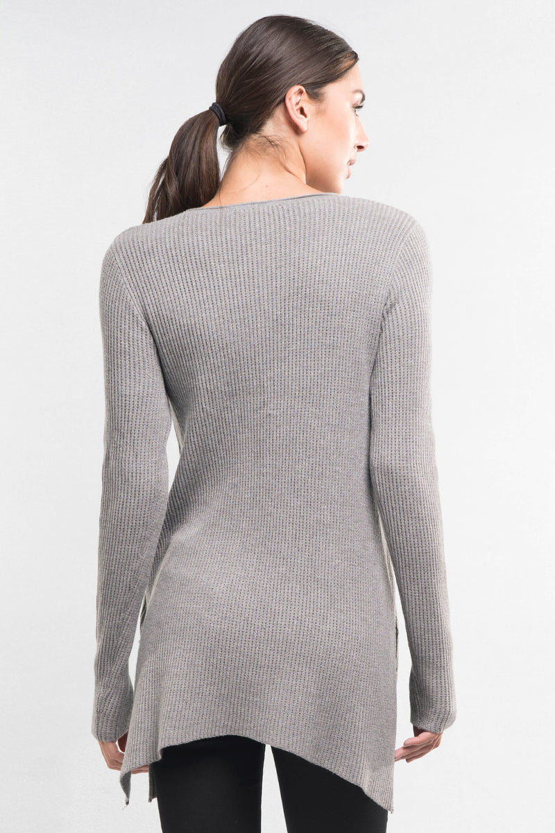 [Color: Heather Ash] A brunette model wearing a grey waffle knit pullover lounge sweater with a crew neckline, long sleeves, and a long hemline with side slits. A basic casual top for everyday styling. 