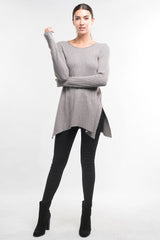 [Color: Heather Ash] A brunette model wearing a grey waffle knit pullover lounge sweater with a crew neckline, long sleeves, and a long hemline with side slits. A basic casual top for everyday styling. 