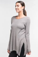 [Color: Heather Ash] A brunette model wearing a grey waffle knit pullover lounge sweater with a crew neckline, long sleeves, and a long hemline with side slits. A basic casual top for everyday styling. 