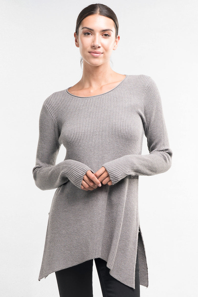 [Color: Heather Ash] A brunette model wearing a grey waffle knit pullover lounge sweater with a crew neckline, long sleeves, and a long hemline with side slits. A basic casual top for everyday styling. 