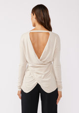 [Color: Bone] A back facing image of a brunette model wearing a soft  knit pullover sweater in ivory. With a comfortable v neckline, long sleeves, and an open back with surplice accent. The perfect basic knit top for any season. 