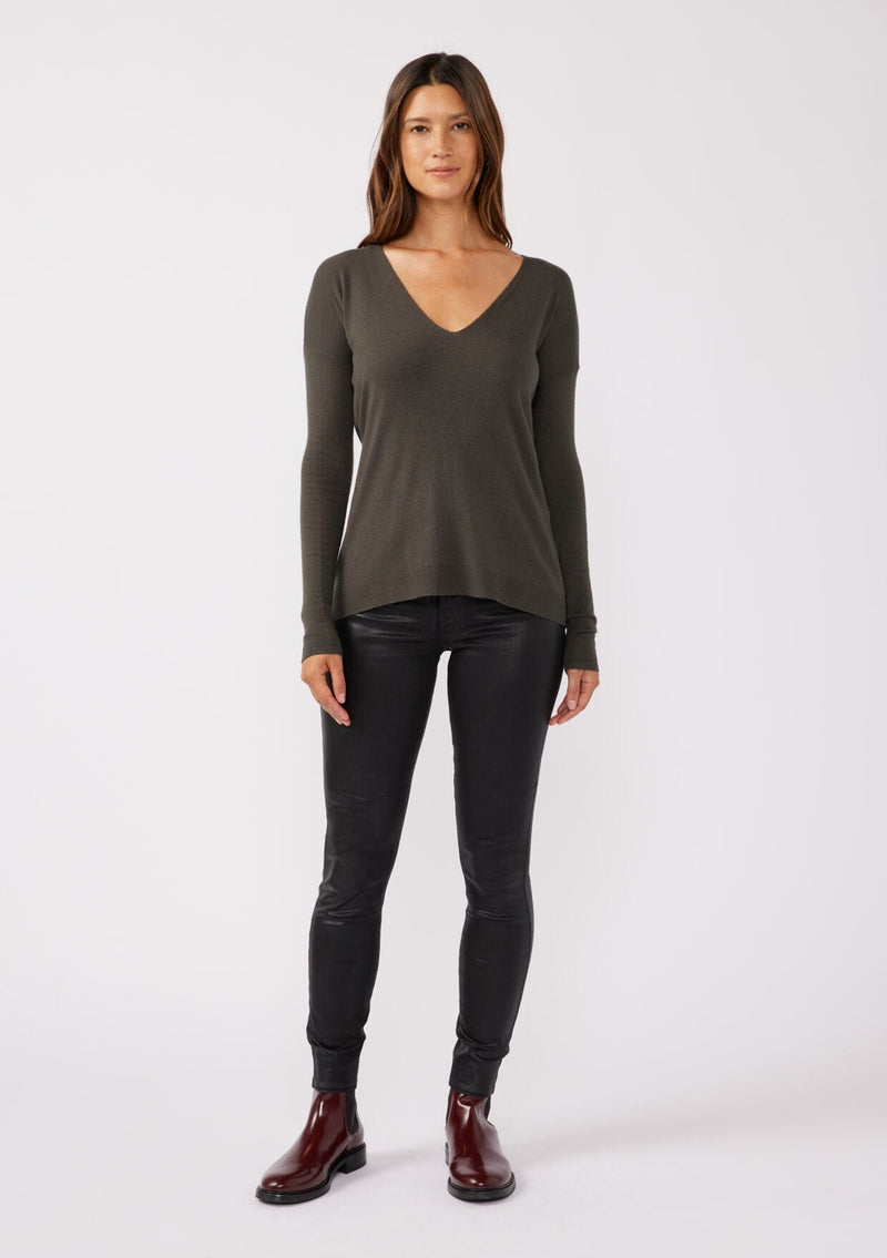 [Color: Hunter] A front facing image of a brunette model wearing a soft knit pullover sweater in dark green. With a comfortable v neckline, long sleeves, and an open back with surplice accent. The perfect basic knit top for any season. 