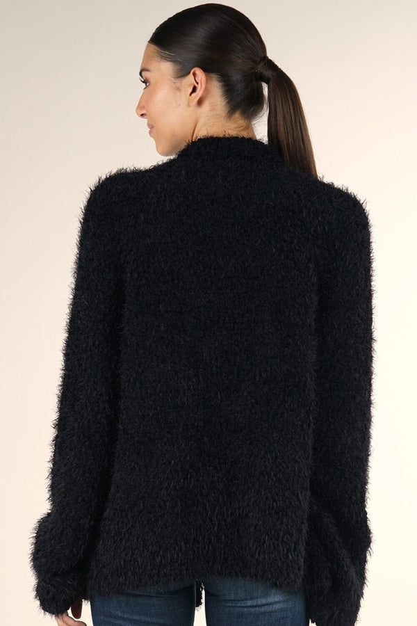 [Color: Black] A brunette model wearing a black fuzzy popcorn textured cardigan with long cozy sleeves, an open front, and patch pockets. 