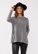 [Color: Heather Charcoal] A grey pocket pullover in a soft knit, featuring breezy side vents, an effortlessly chic rolled crew neckline, and two side pockets. Styled with a black mini dress and black boots for the Fall season. 