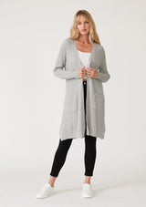 [Color: Heather Silver Grey] A full body front facing image of a blonde model wearing a light heather grey waffle knit cardigan. A lightweight mid length cardigan sweater with long sleeves, side pockets, and an open front. 