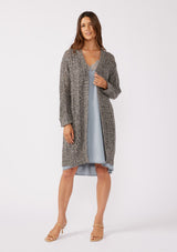 [Color: Charcoal] A full body front facing image of a brunette model wearing a dark charcoal grey open knit cardigan sweater. A mid length lightweight cardigan with long sleeves, an open front, and ribbed wrist cuffs.