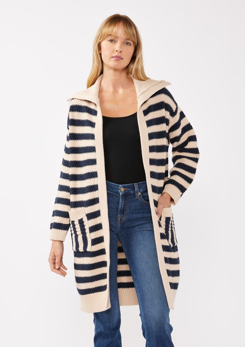 [Color: Navy/Natural] A front facing image of a blonde model wearing a mid length cardigan in a black and white stripe. With long sleeves, a collared neckline, an open front, and side pockets.