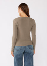 [Color: Dusty Moss] A back image of a brunette model wearing a classic semi fit pullover sweater in a green moss. With a classic square neckline, long sleeves, and a straight hem. 