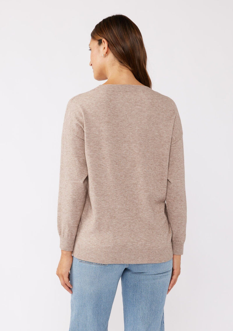 [Color: Heather Mocha] A back facing image of a brunette model wearing a casual light brown pullover sweater with tonal embroidery. This lightweight fall sweater features long sleeves, a classic round neckline, and rib trimming. 