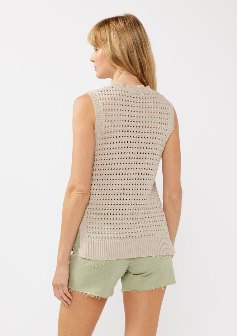 [Color: Mushroom] A back facing image of a blonde model wearing a sleeveless open knit sweater vest with a crew neckline, ribbed trim, and side slits. Perfect for layering over long sleeves or wearing on its own. 