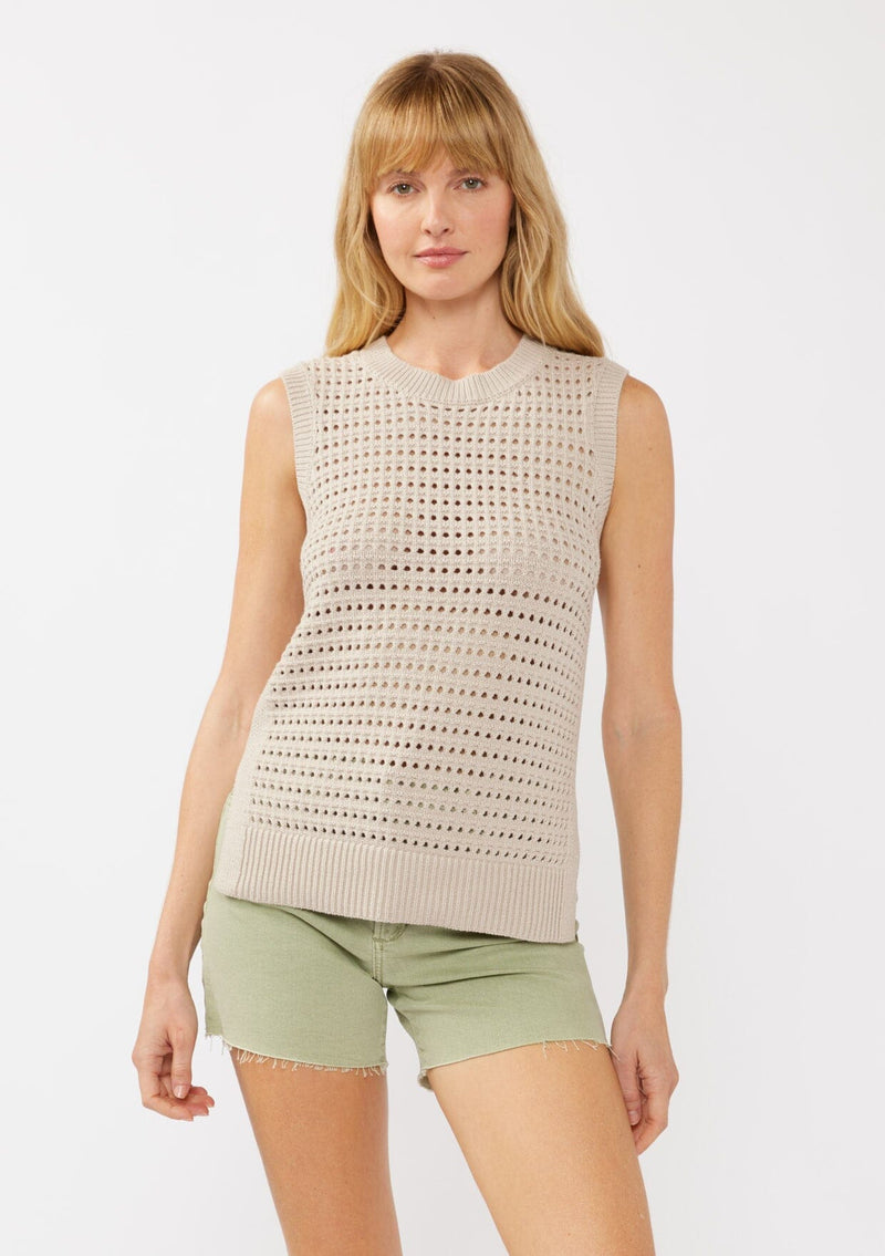 [Color: Mushroom] A front facing image of a blonde model wearing a sleeveless open knit sweater vest with a crew neckline, ribbed trim, and side slits. Perfect for layering over long sleeves or wearing on its own. 