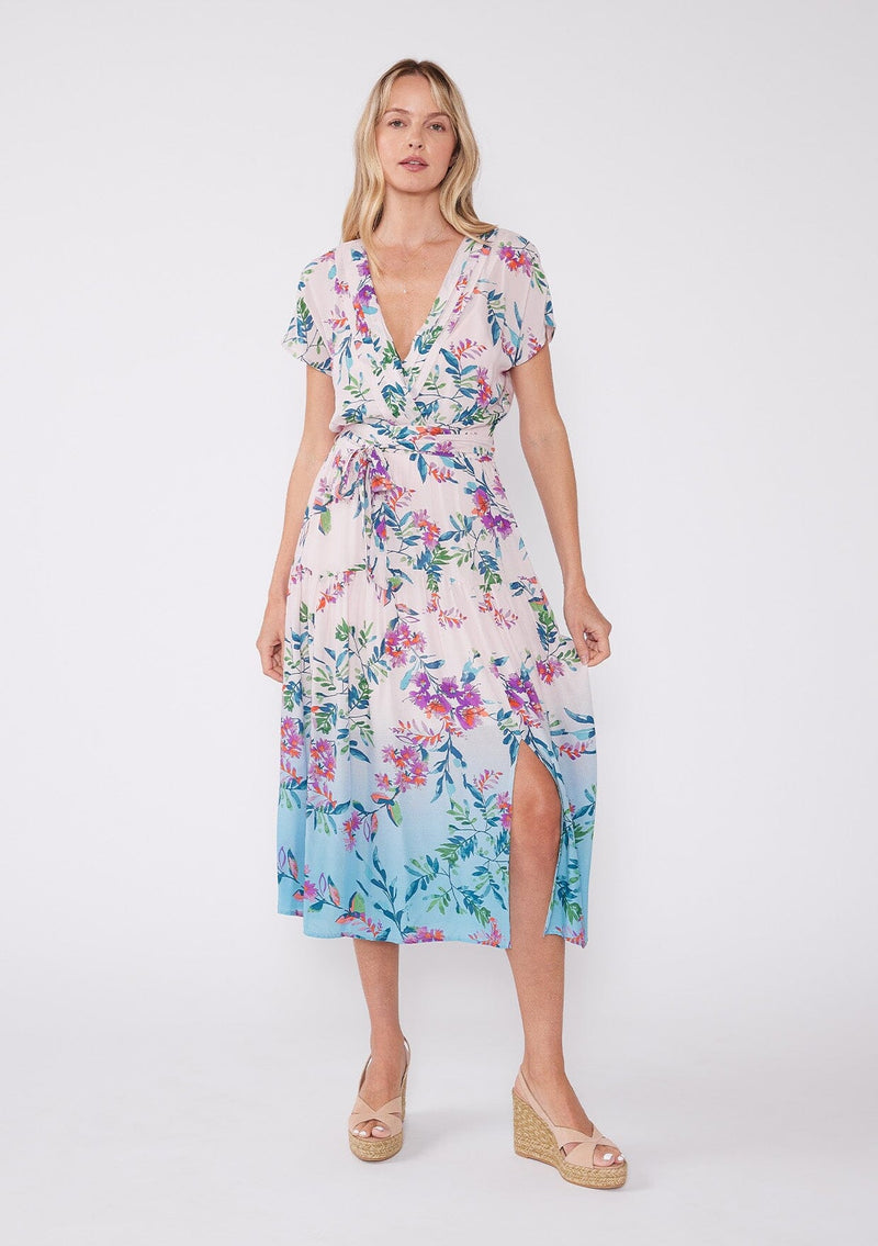 [Color: Light Pink/Purple} A vibrant floral midi dress perfect for vacation. Features a flattering  v neckline with pleated details, short sleeves, adjustable waist belt, smocked back, and front slits. 