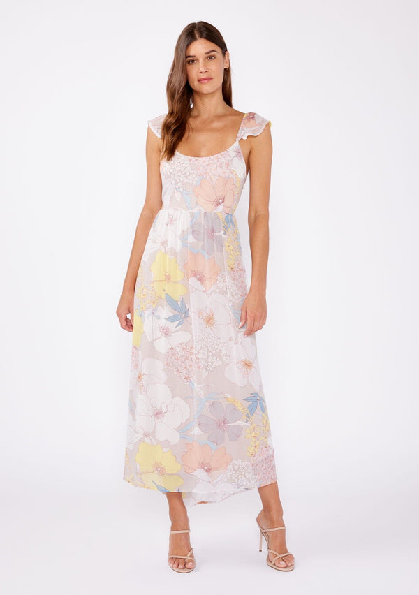 [Color: Natural/Blue] An image of a brunette model wearing a pretty chiffon spring maxi dress designed in a pink and blue floral print. With a slim fit bodice, short flutter cap sleeves, adjustable spaghetti straps, a flowy long skirt, a scooped neckline, and an open back detail with adjustable tie closure.