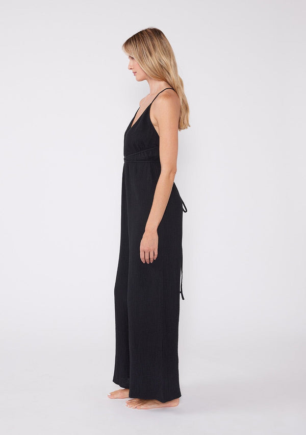 [Color: Black] Lightweight cotton gauze jumpsuit featuring flattering wide legs, a halter v-neckline and strappy open back. A breathable cotton fabric designed to keep you cool all summer long.