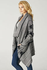 [Color: Ivory/Black] A beautiful chunky black and ivory knit cardigan with a shawl collar and ribbed detail. A western fall style waterfall cardigan with a cascading open front, long sleeves, and cozy side pockets. 