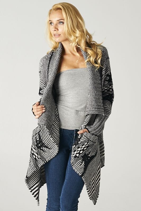 [Color: Ivory/Black] A beautiful chunky black and ivory knit cardigan with a shawl collar and ribbed detail. A western fall style waterfall cardigan with a cascading open front, long sleeves, and cozy side pockets. 