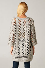 [Color: Light Grey] A model wearing an open knit crochet cardigan with 3/4 length sleeves, and a snap button front. 