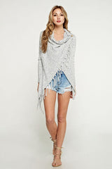 [Color: Blue/Vanilla] A blonde model wearing a blue and ivory speckled cardigan with a wrap front. Featuring a fringed hem, long sleeves, and a relaxed fit. 