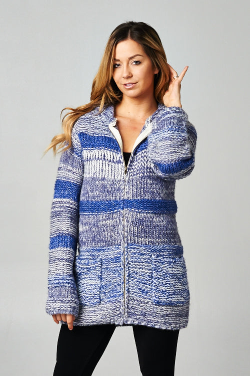 [Color: Denim Blue] A blonde model wearing a blue marled stripe knit cardigan with a zipper front, hoodie, and patch pockets. 