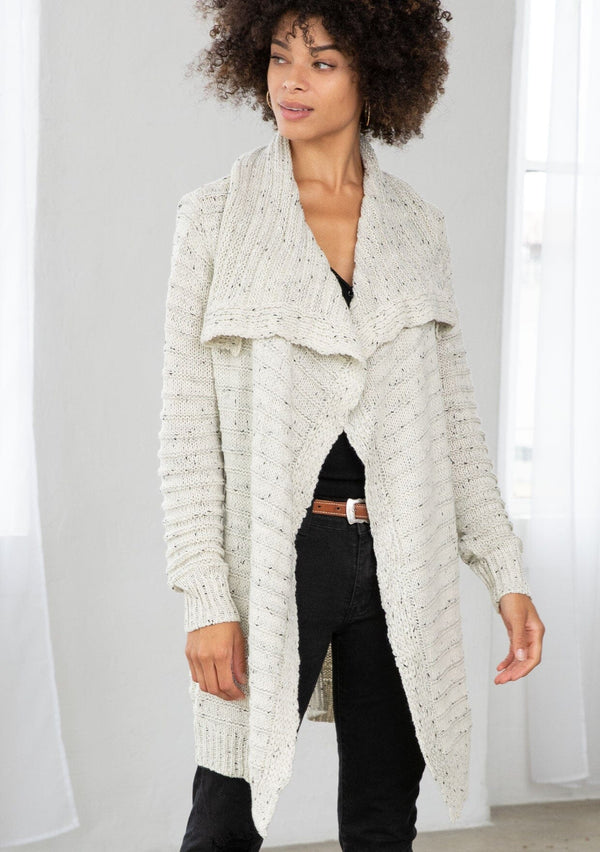 [Color: Cream/Black] A bohemian speckled knit grey cardigan with long sleeves, an open front, and an oversized lapel. 