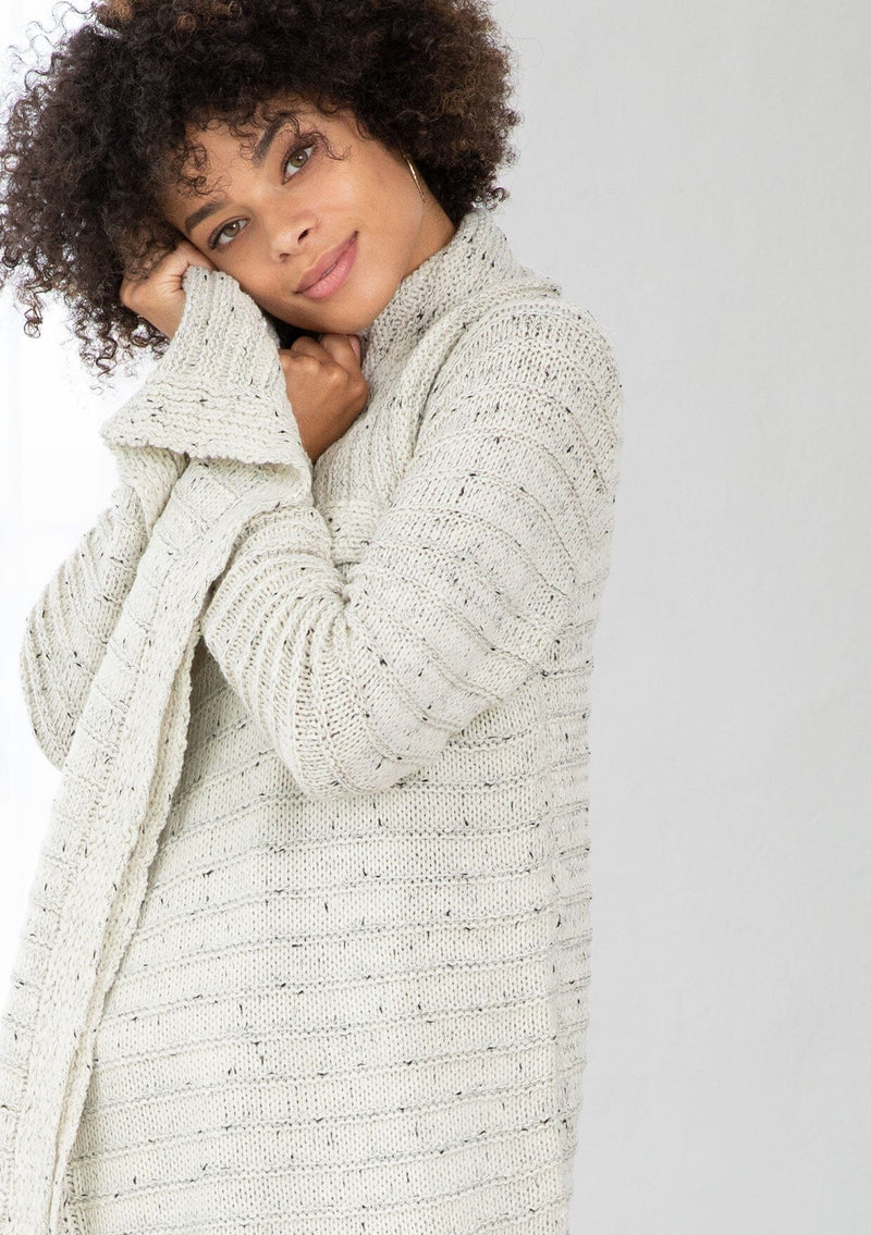 [Color: Cream/Black] A bohemian speckled knit grey cardigan with long sleeves, an open front, and an oversized lapel. 