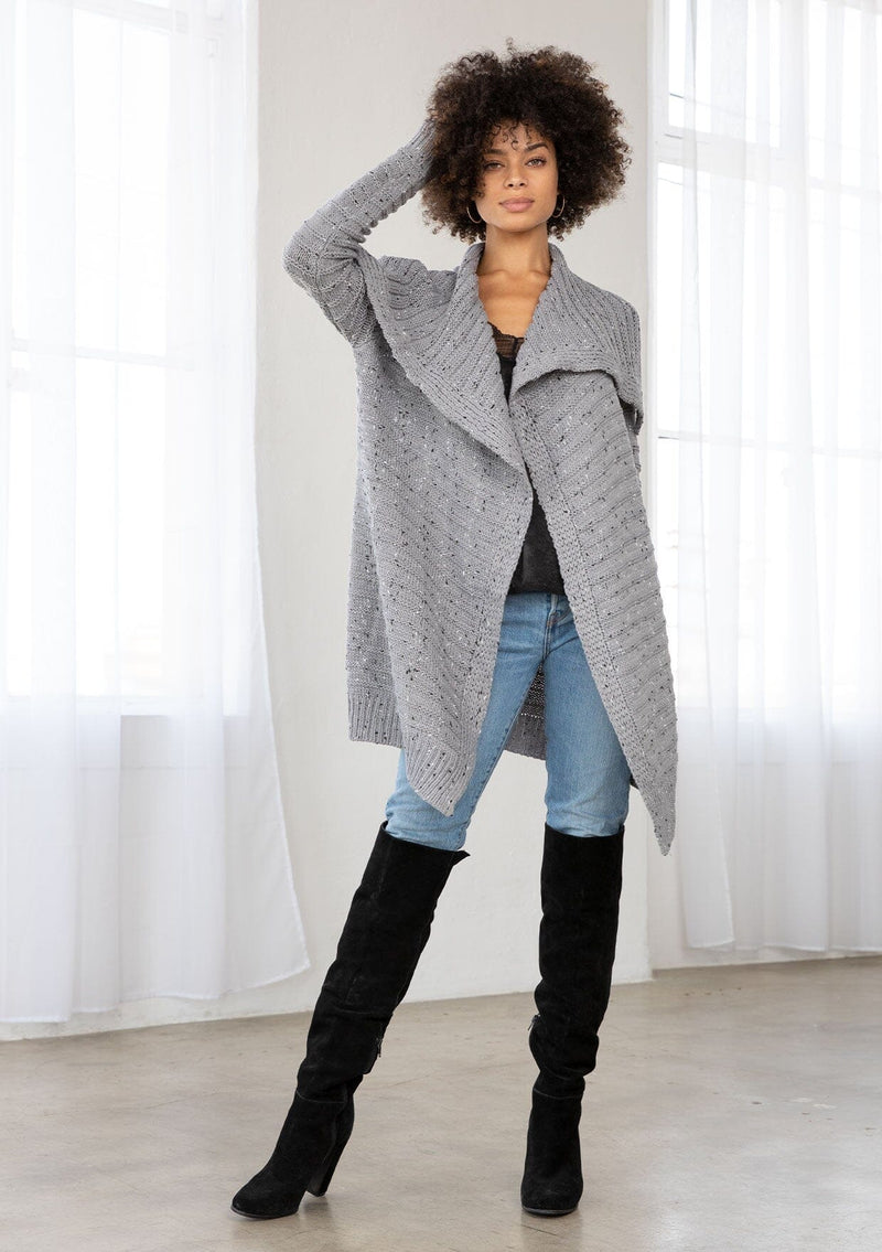 [Color: Grey/Black] A bohemian speckled knit grey cardigan with long sleeves, an open front, and an oversized lapel. 