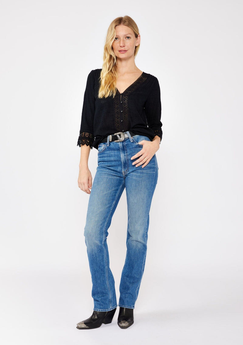 [Color: Black] A blonde model wearing a textured cotton blouse in black. With lace and crochet trims, functional button front, v neckline, and relaxed fit. A casual bohemian top styled with a western black buckle belt and paired with denim jeans and black boots. 