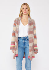 [Color: Natural/Dusty Clay] A blonde model wearing an ultra soft cardigan in a multicolor heather stripe knit. Featuring an open front, relaxed shawl collar, and cozy long sleeves. Paired and styled with vintage denim and boots for the ultimate fall look.