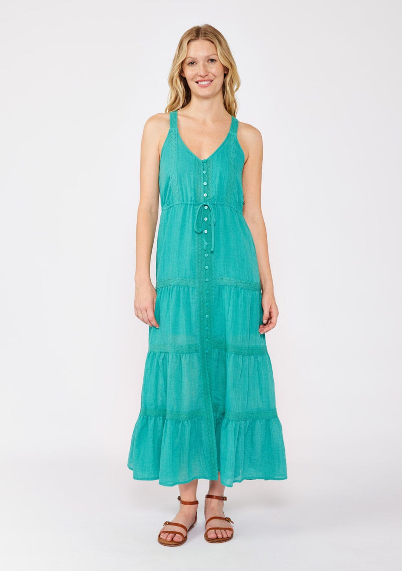 [Color: Teal] A blonde model wearing a Victorian  vintage inspired bohemian maxi dress in the color teal. With a v neckline, button front, and delicate lace trims. A summer tank maxi dress with a flowy relaxed fit paired with brown strappy sandals for warm weather. 