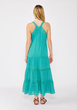 [Color: Teal] A blonde model wearing a Victorian vintage inspired bohemian maxi dress in the color teal. With a v neckline, button front, and delicate lace trims. A summer tank maxi dress with a flowy relaxed fit paired with brown strappy sandals for warm weather.