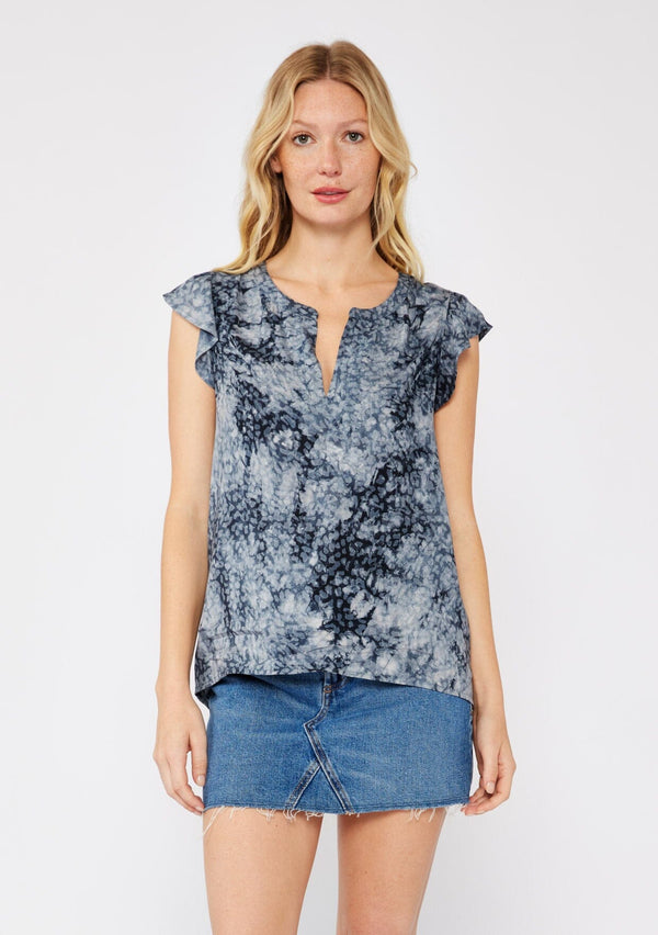 [Color: Indigo] A blonde model wearing a blue animal print top with a denim mini skirt. A relaxed fit top with a split v neckline and short flutter sleeves. 