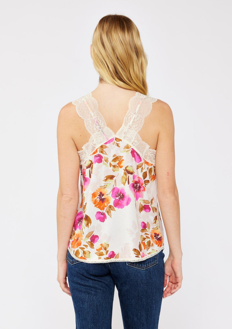 [Color: Natural/Orchid] A blonde model wearing a pretty lace trim cami tank top. A floral print tank with a v neckline, racerback, and relaxed fit. Styled with dark denim jeans for the perfect fall look.