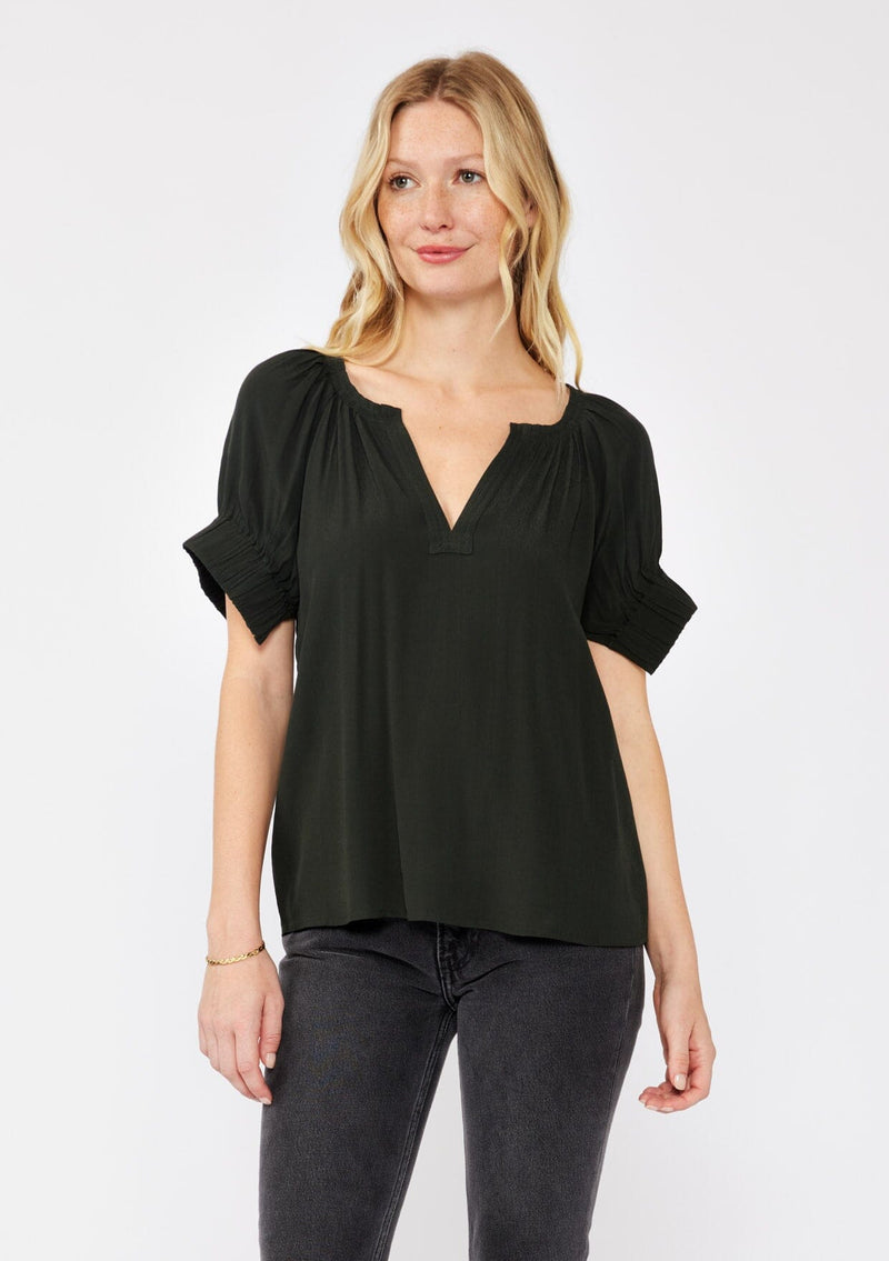 [Color: Dark Green] A blonde model wearing a classic green top with a unique puff sleeve. Featuring a split v-neckline, relaxed fit, and wide elastic cuffs with split detail. A solid olive green top perfect for the office or casual outings. 