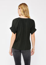 [Color: Dark Green] A blonde model wearing a classic green top with a unique puff sleeve. Featuring a split v-neckline, relaxed fit, and wide elastic cuffs with split detail. A solid olive green top perfect for the office or casual outings.