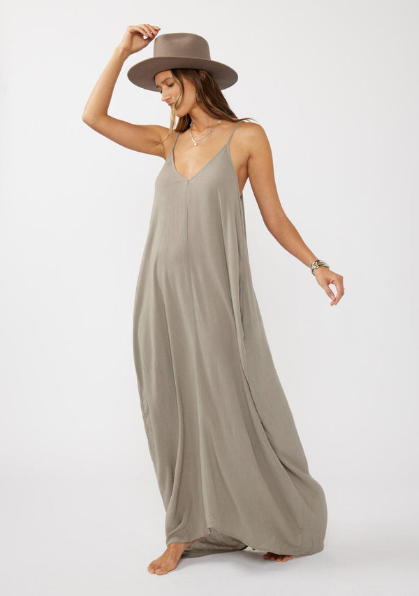 [Color: Cement] A grey harem maxi dress. This billowy maxi tank top dress features a deep v neckline, adjustable spaghetti straps, and a cocoon fit.