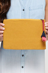 [Color: Mustard Multi] An image of a yellow embroidered clutch with a tassel zipper pull. 