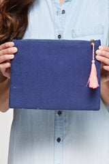 [Color: Multi] An image of a multi color cotton clutch with intricate embroidery and a tassel zipper pull. 