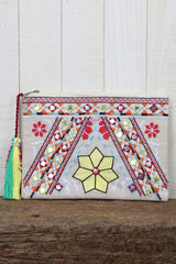 [Color: Yellow/Natural] A boho multi color embroidered clutch bag with a tassel zipper pull. 