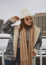 [Color: Denim Blue] A front-facing image of a blonde model wearing a denim floral jacket with a sherpa lining. The jacket features a cozy shawl collar, open front, patch pockets, long sleeves, and fold-over cuffs with exposed sherpa. A cold weather essential. 