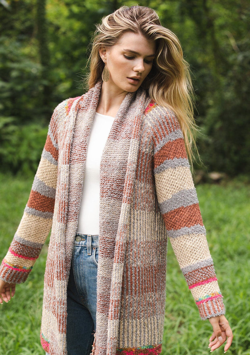 [Color: Natural/Dusty Clay] A blonde model wearing an ultra soft cardigan in a multicolor heather stripe knit. Featuring an open front, relaxed shawl collar, and cozy long sleeves. Paired and styled with vintage denim.