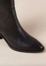 [Color: Black] A black leather boot with a side zipper and small slanted block heel. Made in Portugal. Designed in Spain. 