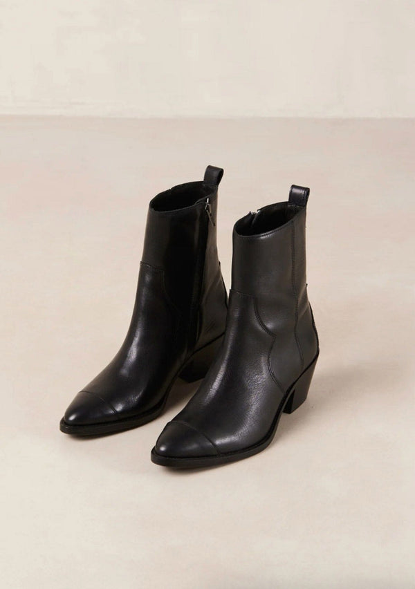 [Color: Black] A black leather boot with a side zipper and small slanted block heel. Made in Portugal. Designed in Spain. 