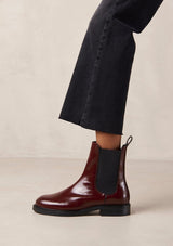 [Color: Burgundy] An elevated version of a classic chelsea boot crafted in red leather with a glossy finish. with elastic gores, thick rubber soles, and pull tab. A perfect trendy boot for the fall season. Designed by Alohas in Spain and Portugal.